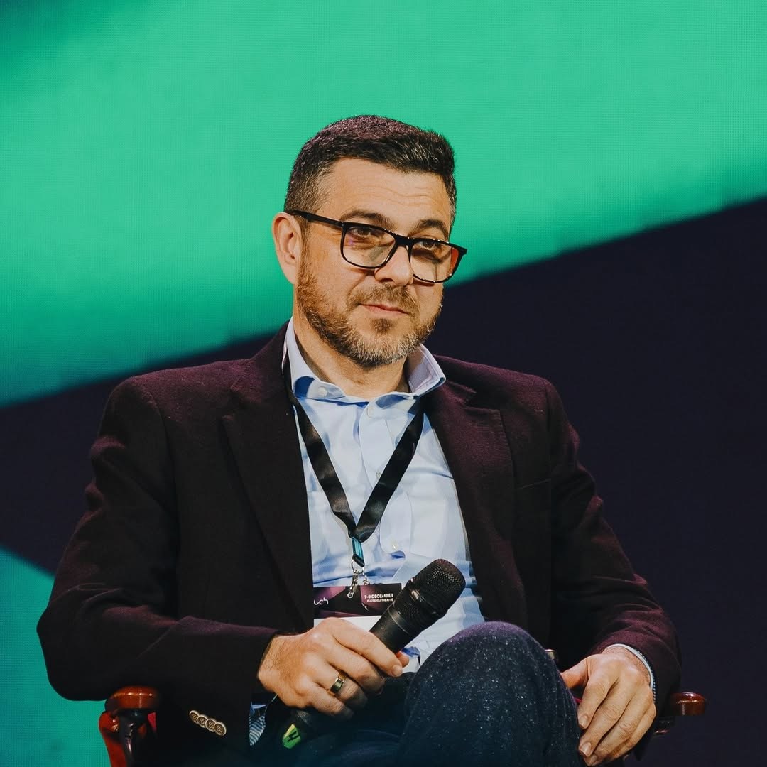 Emin Aliev speaking on a conference panel